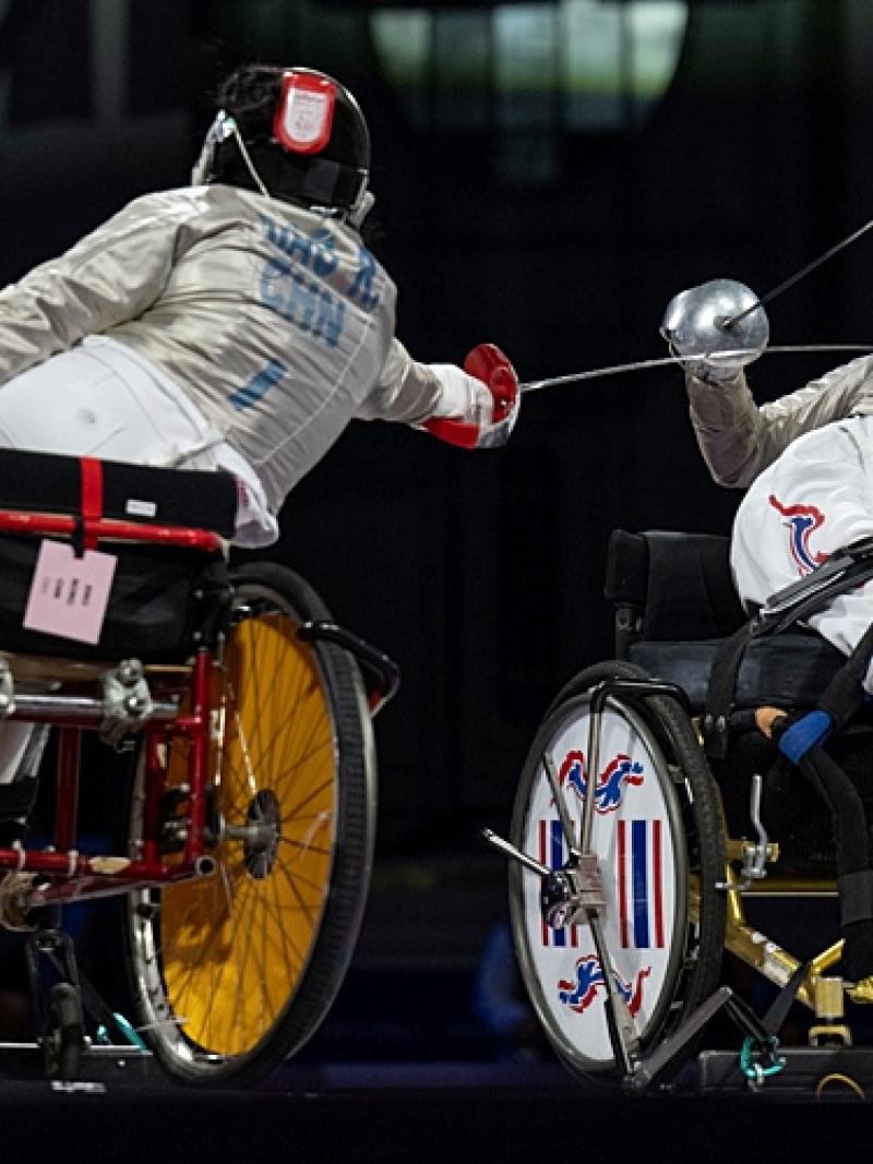 Two Para fencing athletes in action